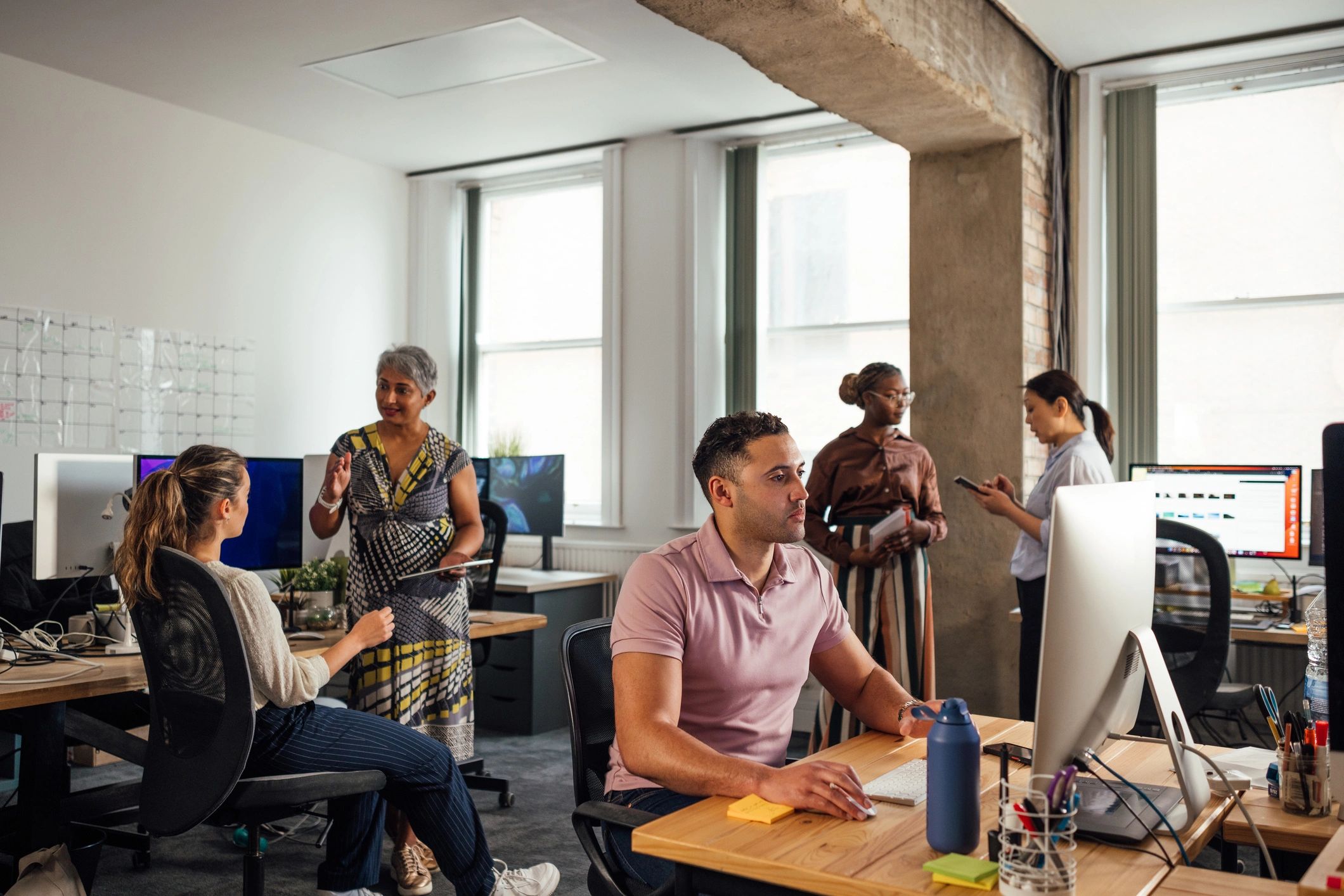 Team members learning together in a modern office setting