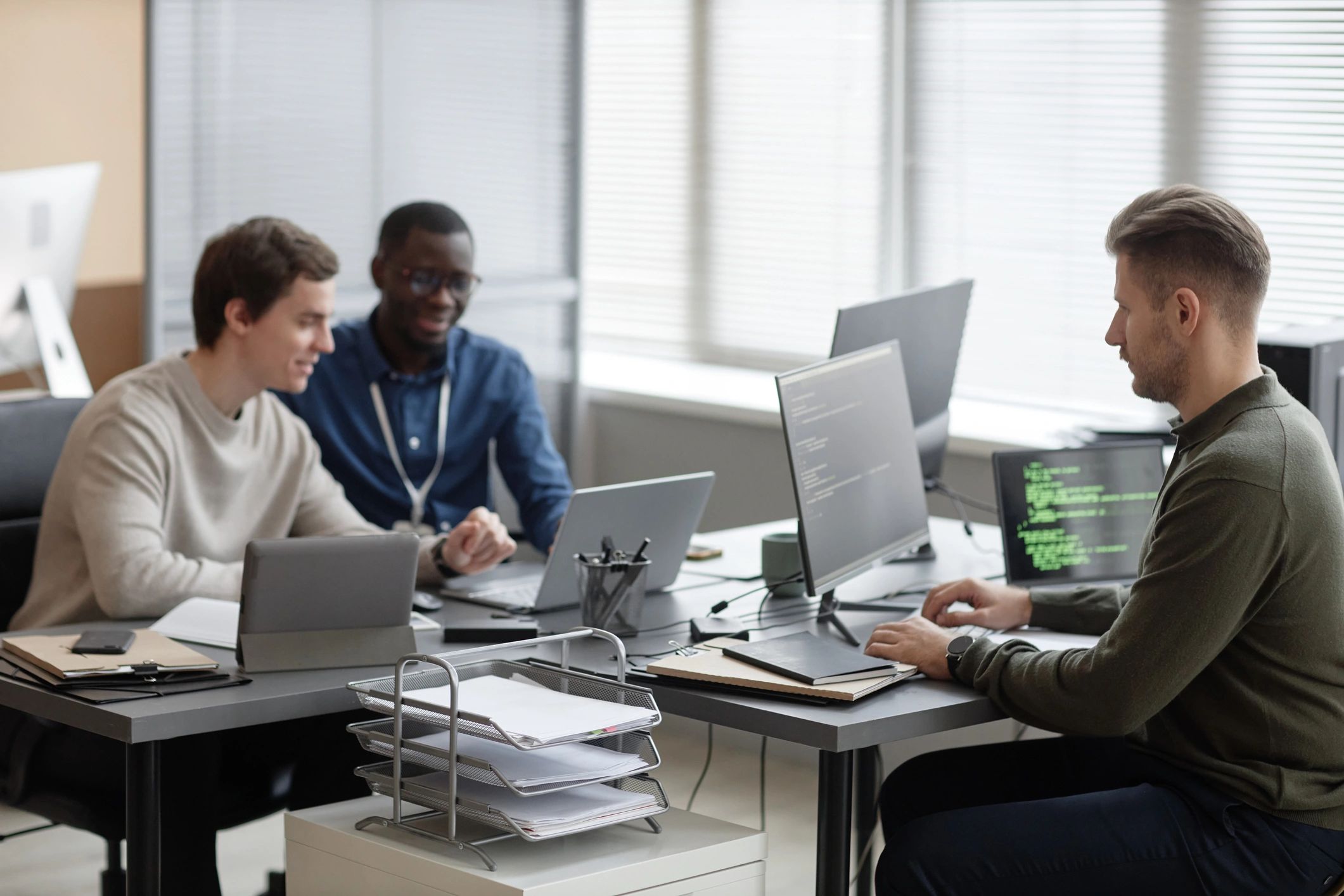 IT professionals collaborating on cybersecurity and consulting work in a modern office