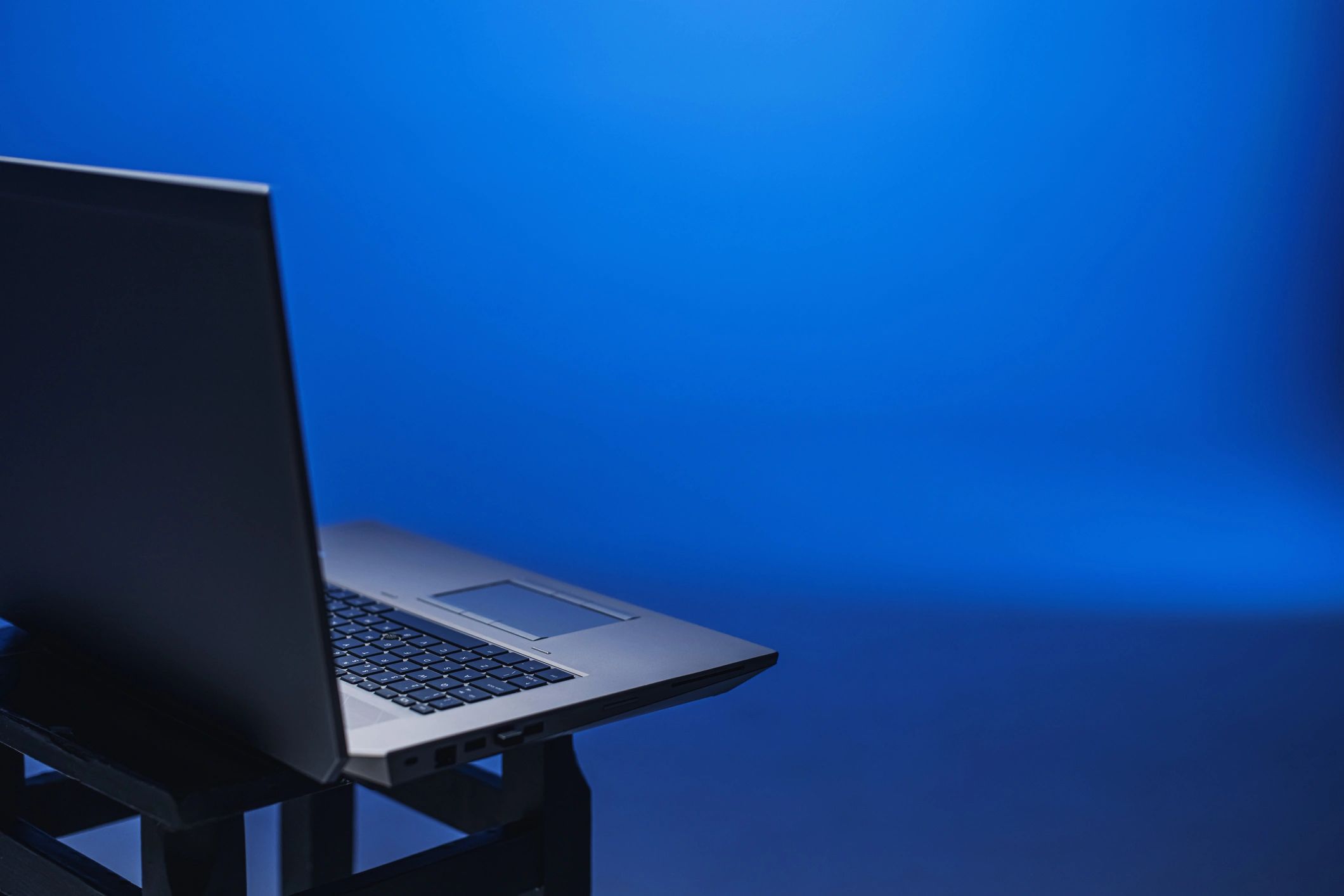 Laptop on blue background representing technology strategy